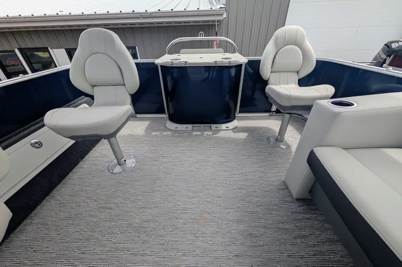 Slide: The Image of 2026 Starcraft EX 20 F boat interior with swivel seats and carpeted flooring. - 3