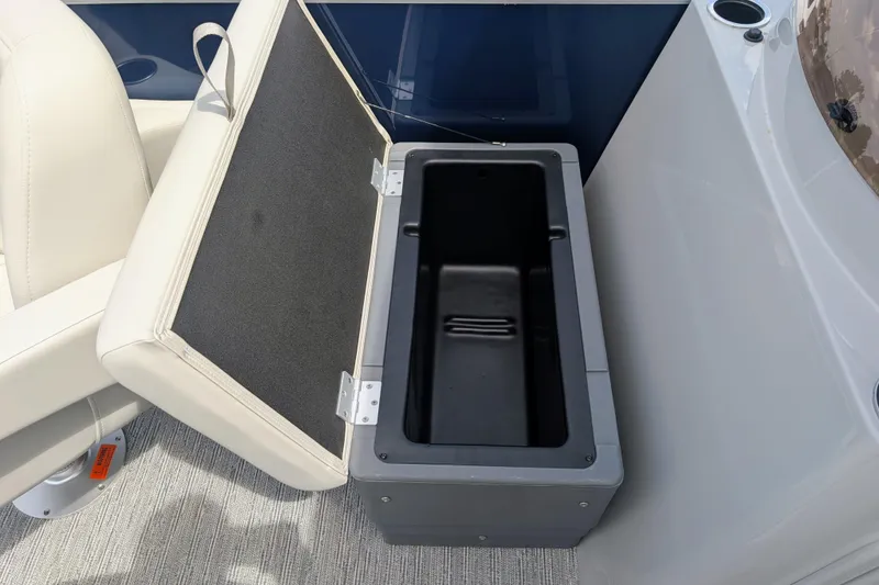 Slide: The Image of Open storage compartment on 2026 Starcraft EX 20 F boat, featuring cushioned seating. - 9