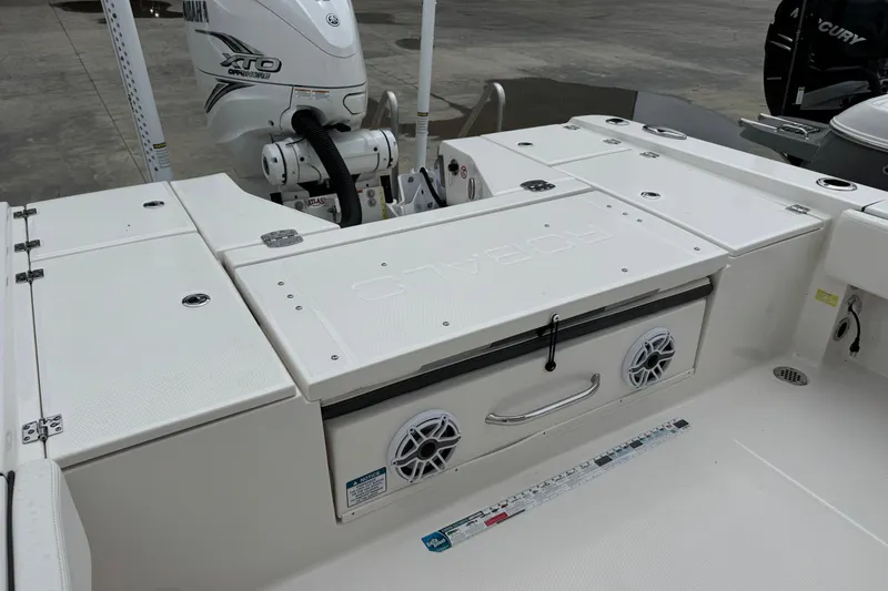 Slide: The Image of 2023 Robalo 266 Cayman boat deck with storage compartments and Yamaha engine. - 13
