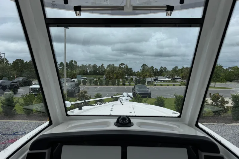 Slide: The Image of View from inside a 2023 Robalo 266 Cayman boat, overlooking a parking lot. - 17