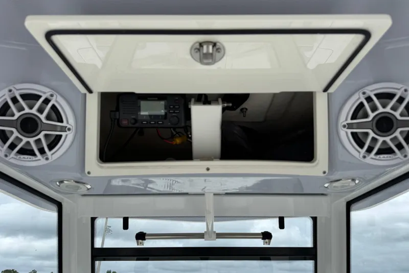 Slide: The Image of 2023 Robalo 266 Cayman boat console with speakers and electronic equipment. - 18