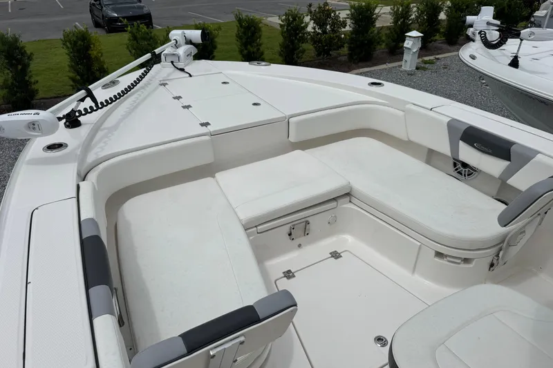 Slide: The Image of 2023 Robalo 266 Cayman boat interior with cushioned seating and storage compartments. - 19