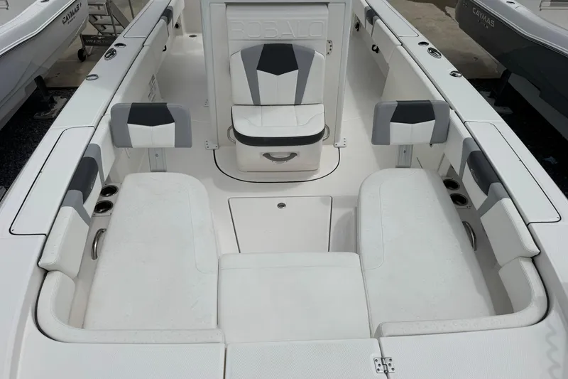 Slide: The Image of 2023 Robalo 266 Cayman boat interior with white seating and storage compartments. - 21