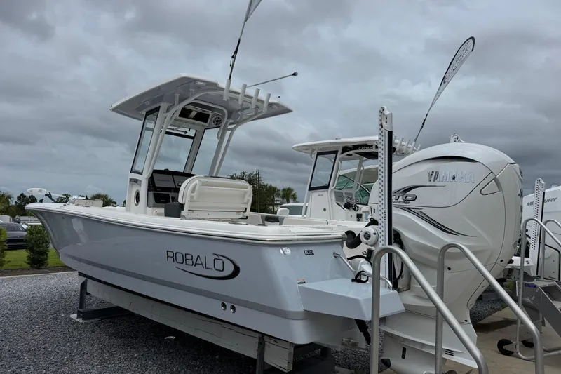 Slide: The Image of 2023 Robalo 266 Cayman boat displayed outdoors with Yamaha engine. - 3