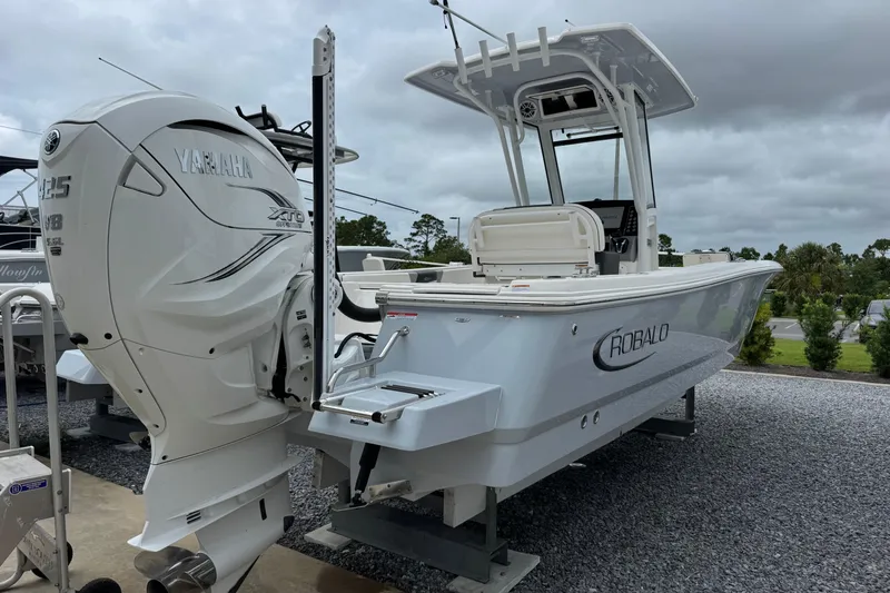 Slide: The Image of 2023 Robalo 266 Cayman boat with Yamaha XTO engine, displayed outdoors. - 5