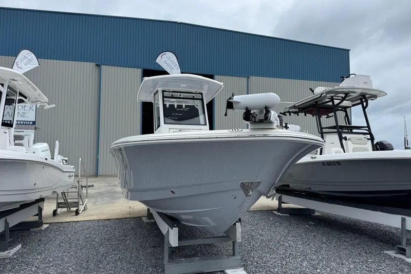 Slide: The Image of 2023 Robalo 266 Cayman boat displayed at a marina, front view. - 6