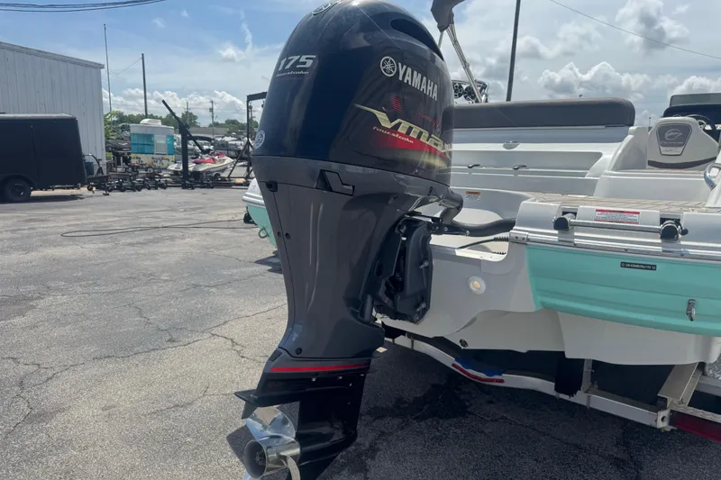 Slide: The Image of 2022 Crownline Eclipse E205 XS Fish with Yamaha 175 outboard motor in a marina setting. - 12
