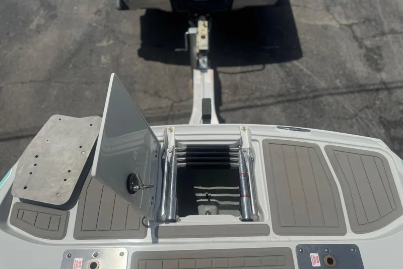 Slide: The Image of 2022 Crownline Eclipse E205 XS Fish boat with open storage compartment and trailer attachment. - 13