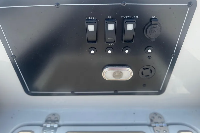 Slide: The Image of Control panel of 2022 Crownline Eclipse E205 XS Fish boat with switches and 12V outlet. - 14