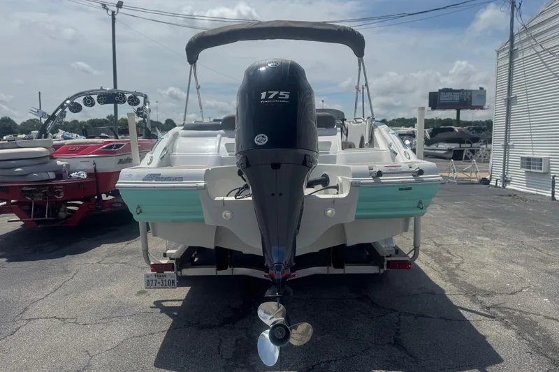 Slide: The Image of 2022 Crownline Eclipse E205 XS Fish boat with 175 HP engine, parked outdoors. - 4