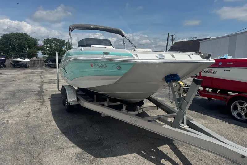 Slide: The Image of 2022 Crownline Eclipse E205 XS Fish boat on trailer, parked outdoors. - 7