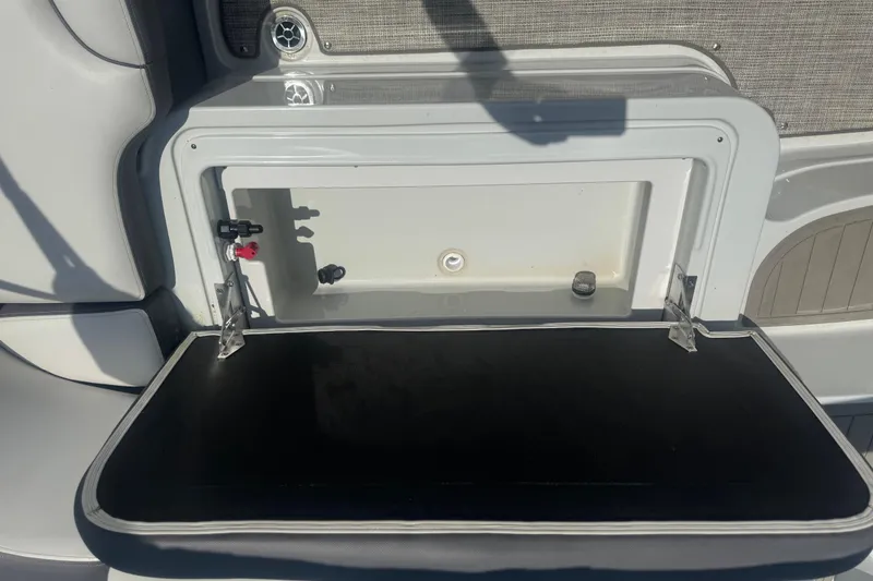 Slide: The Image of 2022 Crownline Eclipse E205 XS Fish boat storage compartment with open lid. - 8
