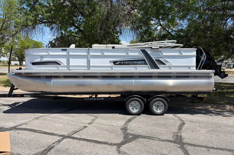 The Image of 2026 Starcraft EX 22 FD4 pontoon boat on trailer, parked outdoors. - 1