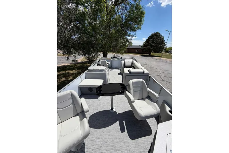 Slide: The Image of 2026 Starcraft EX 22 FD4 pontoon boat interior with seating and table. - 3