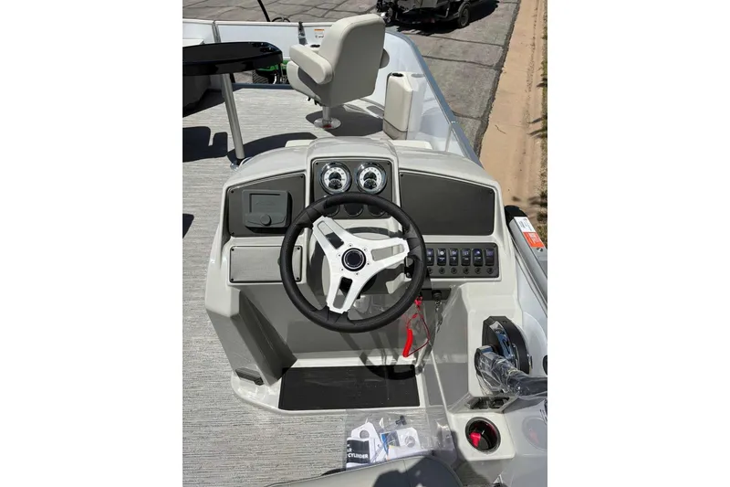 Slide: The Image of Steering console of 2026 Starcraft EX 22 FD4 boat with modern controls and gauges. - 4