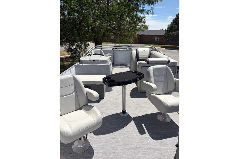 Slide: The Image of 2026 Starcraft EX 22 FD4 pontoon boat interior with plush seating and table. - 5