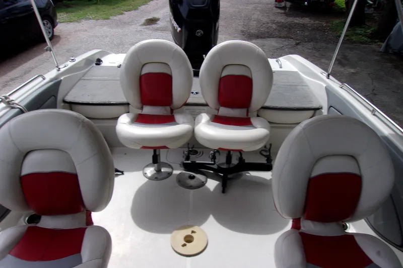Slide: The Image of Interior of 2013 Nitro 290 Sport boat with red and white seating. - 13