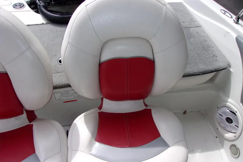 Slide: The Image of Red and white seats on a 2013 Nitro 290 Sport boat interior. - 15