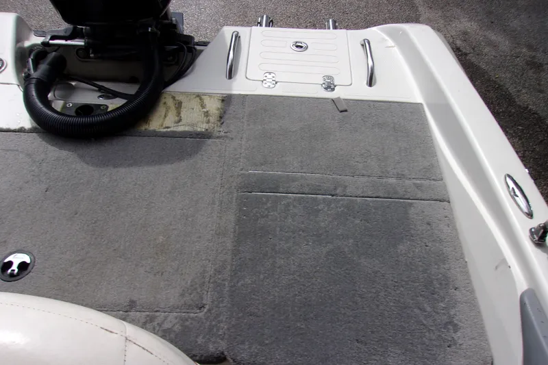 Slide: The Image of 2013 Nitro 290 Sport boat deck with gray carpet and motor mount. - 16