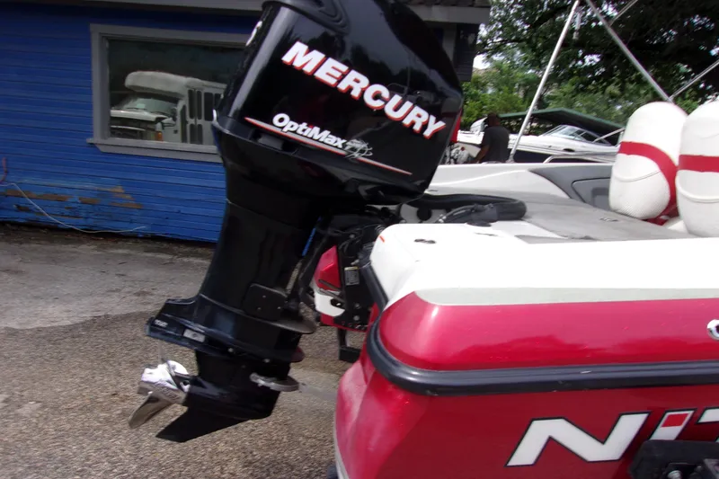 Slide: The Image of 2013 Nitro 290 Sport boat with Mercury OptiMax engine, parked outdoors. - 3