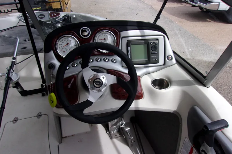 Slide: The Image of 2013 Nitro 290 Sport boat dashboard with steering wheel, gauges, and navigation system. - 5
