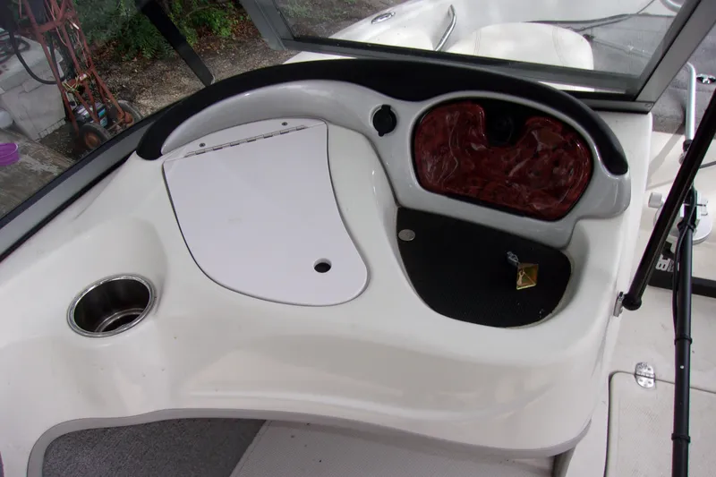 Slide: The Image of Interior view of a 2013 Nitro 290 Sport boat dashboard with cup holder. - 8