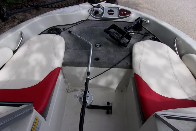 Slide: The Image of Interior of a 2013 Nitro 290 Sport boat with red and white seating. - 9