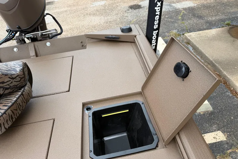 Slide: The Image of 2026 Xpress XP170 boat deck with open storage compartment and camouflage seat. - 5
