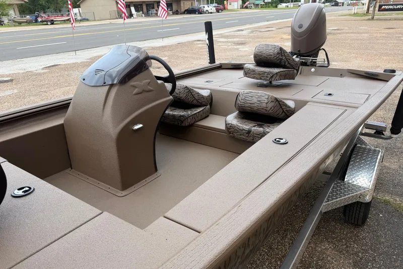 Slide: The Image of 2026 Xpress XP170 boat interior with camouflage seats and steering console. - 6