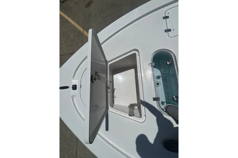Slide: The Image of Open storage compartment on 2026 Sea Pro 250 Bay boat deck. - 10