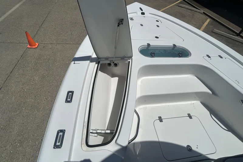 Slide: The Image of 2026 Sea Pro 250 Bay boat deck with open storage compartment. - 11