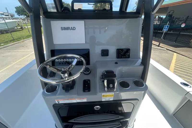 Slide: The Image of 2026 Sea Pro 250 Bay boat console with Simrad electronics and Suzuki controls. - 13