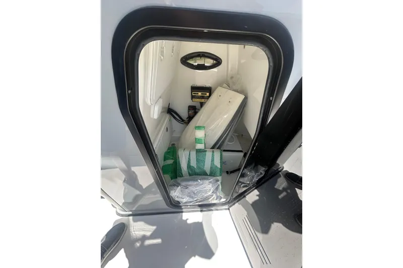 Slide: The Image of Interior storage compartment of 2026 Sea Pro 250 Bay boat, featuring various equipment. - 19