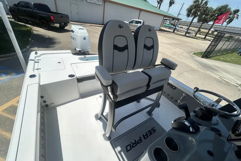 Slide: The Image of 2026 Sea Pro 250 Bay boat interior with dual seats and Suzuki outboard motor. - 20