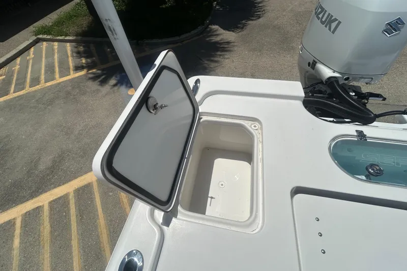 Slide: The Image of Open storage compartment on 2026 Sea Pro 250 Bay boat with Suzuki engine. - 23