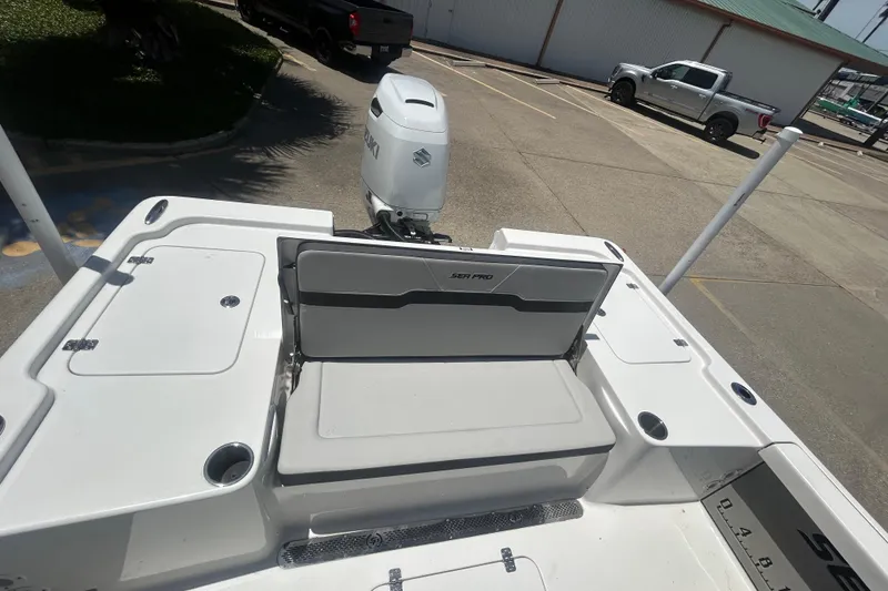 Slide: The Image of 2026 Sea Pro 250 Bay boat with Suzuki outboard engine in a parking lot. - 24