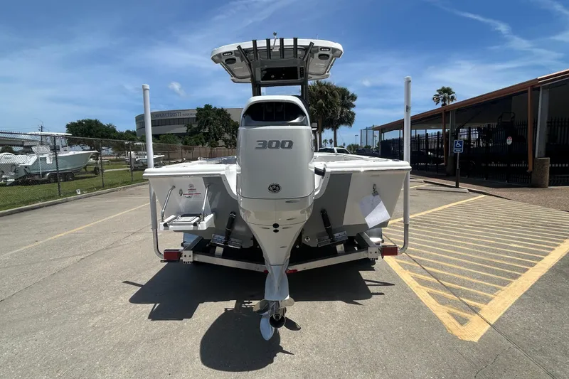 Slide: The Image of 2026 Sea Pro 250 Bay boat with 300 horsepower engine, parked outdoors. - 5