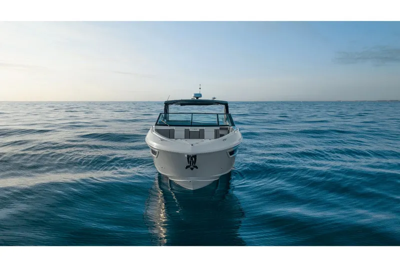 Slide: The Image of 2027 Cruisers Yachts 38GLS-OB on calm sea at sunset. - 4