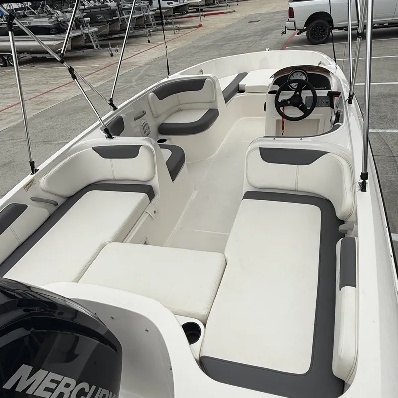Slide: The Image of Interior view of 2025 Bayliner E18LE boat with gray and white seating. - 9
