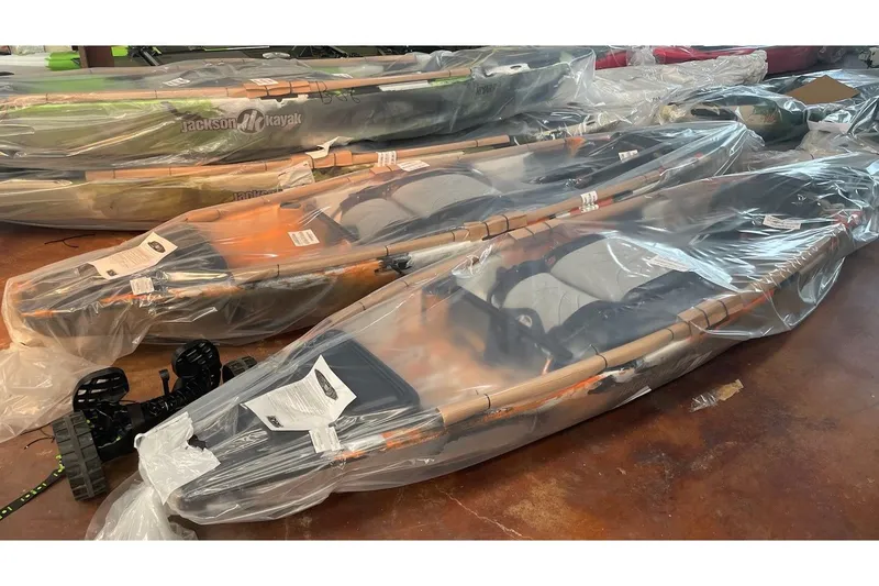 The Image of Packaged Jackson KNARR kayaks, 2022 model, on warehouse floor. - 1