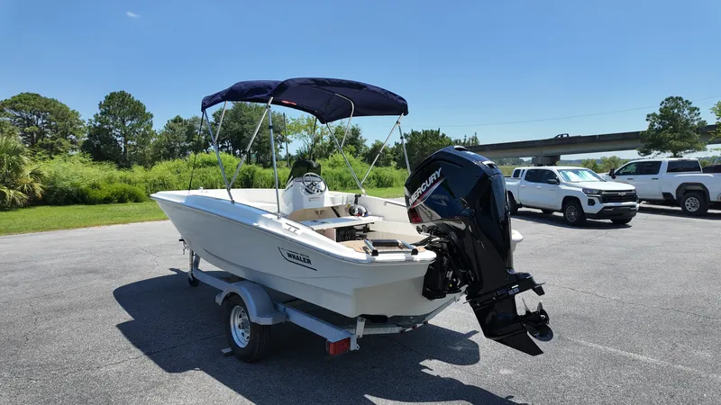 Slide: The Image of A 2027 Boston Whaler 160 Super Sport on a trailer. It features a blue sunshade. - 3