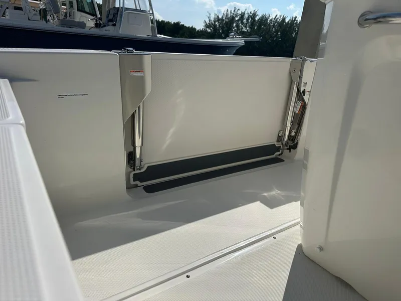 Slide: The Image of The 2027 Boston Whaler 280 Dauntless features an open door to the swim platform. - 16
