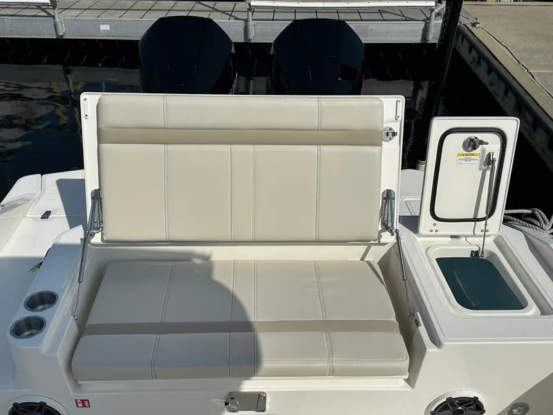 Slide: The Image of The 2027 Boston Whaler 280 Dauntless features a cushioned bench seat and a sink. - 20