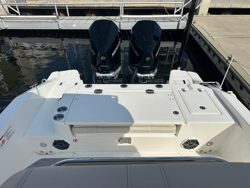 Slide: The Image of The image shows the stern of a Boston Whaler 280 Dauntless with two outboard engines at a dock. - 19