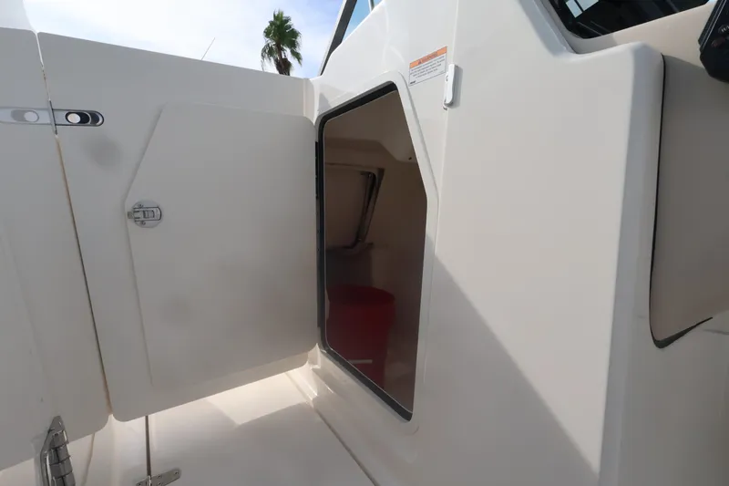 Slide: The Image of The 2027 Boston Whaler 240 Vantage features an open door to a storage compartment. - 29