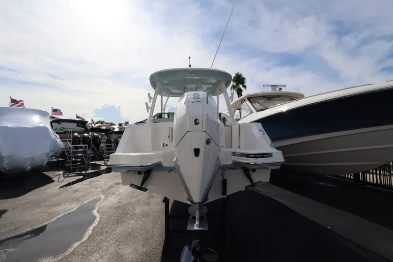 Slide: The Image of A 2027 Boston Whaler 240 Vantage is parked, surrounded by other boats. - 4