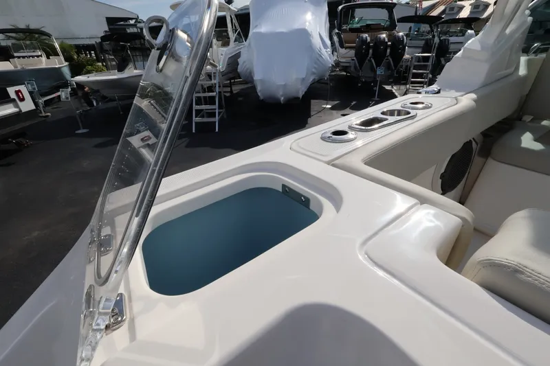 Slide: The Image of The image shows the cockpit of a Boston Whaler 240 Vantage with an open storage compartment. - 10