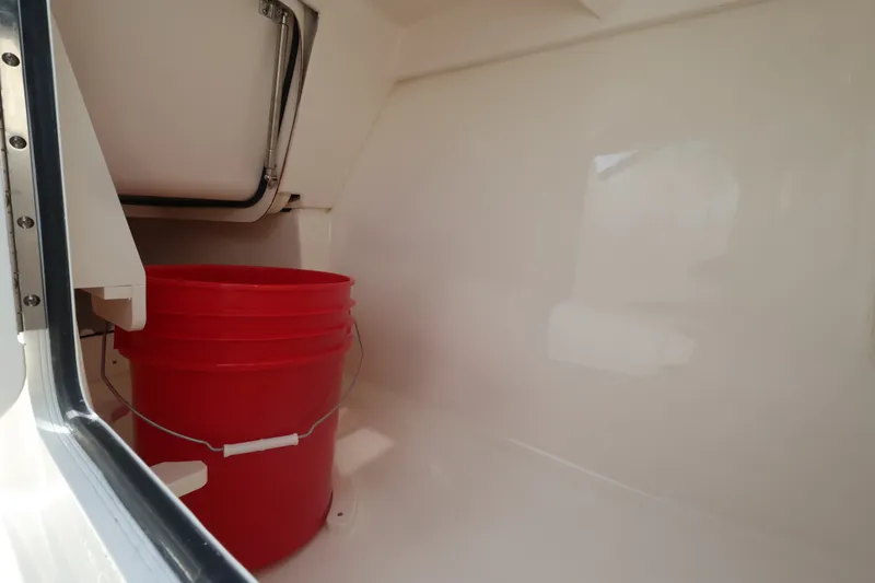 Slide: The Image of Interior of a boat with a red bucket and a closed storage compartment hatch. - 30