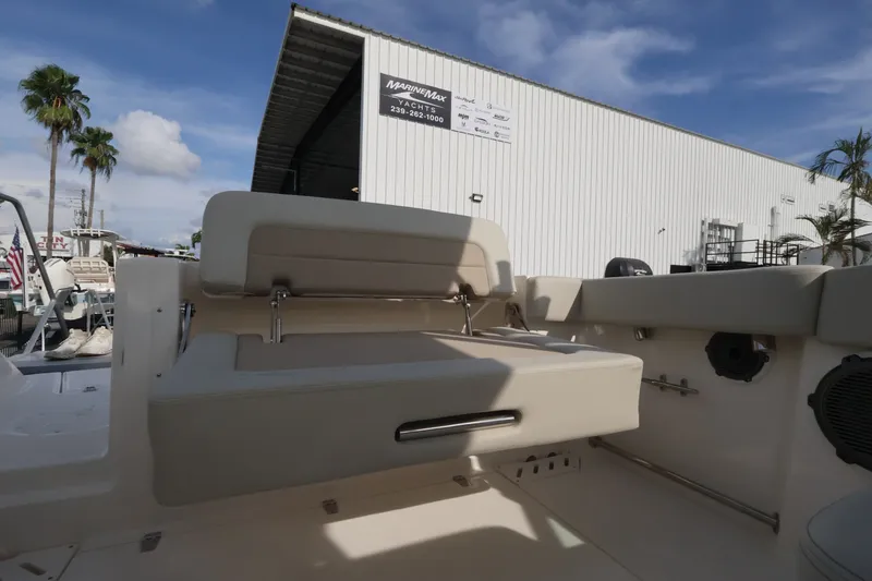 Slide: The Image of The image shows the cockpit of a 2027 Boston Whaler 240 Vantage with beige seating. - 13