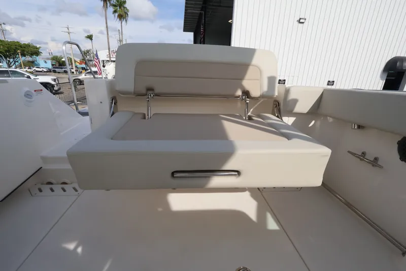 Slide: The Image of The 2027 Boston Whaler 240 Vantage features a beige, cushioned bench seat in the rear area. - 14